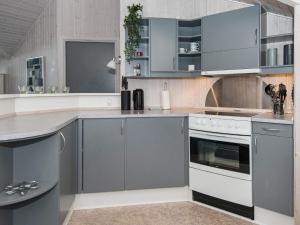 a kitchen with gray cabinets and white appliances at Luxury Spa Retreat in Ebeltoft - By Traum Ferienwohnungen in Ebeltoft +15 photos