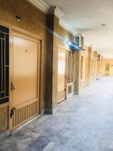 an empty hallway of a building with a door at Al Wasay Guest House & Restaurant in Dargai