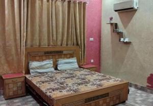 a bedroom with a large bed in a room at Al Wasay Guest House & Restaurant in Dargai