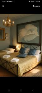 two beds in a room with a painting on the wall at Il Casale dell'Abate B&B - GUARDEA UMBRIA in Cocciano