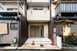 a building with two orange cones in front of it at 夏様二条南 6 min walk Nijo St, Entire private house, 3 bedrooms, Up to 6 guests, 2 toilets in Kyoto
