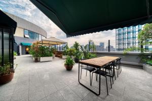 a patio with a table and chairs on a balcony at Wander Lodge Youth Hostel in Chengdu