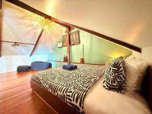a bedroom with a zebra print bed in a room at Alitaptap Villa by Lugadia Villas in El Nido