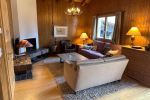 a living room with a couch and a table at Chalet Arnica in Fiesch