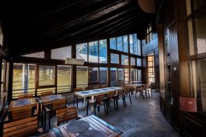a large room with tables and chairs and windows at Pensiunea Crystal in Iaşi