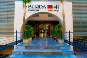 an entrance to a building with stairs and potted plants at Burda 41 Hotel & Suites in Amman