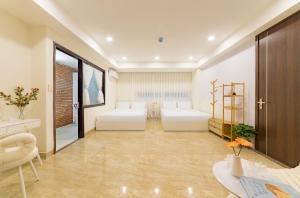 a large room with two white beds in it at Danang's house in Da Nang +61 photos