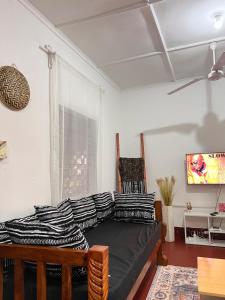 a living room with a couch and a tv at SafariHouse in Malindi