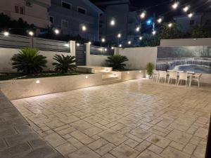 a patio at night with tables and chairs at Villa Mondi in Golem