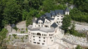 a large white house with a black roof at Zámoček Mraznica in Prievidza