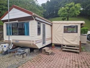 カンボ・レ・バンにあるMon Petit Mobil Homeの車道の上に建つ白い小さな家