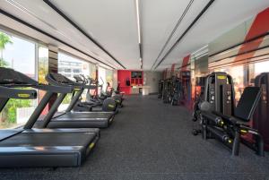 a gym with rows of treadmills and machines at Centara Karon Villas Phuket in Karon Beach