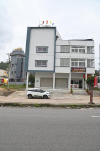 a white car parked in front of a building at Sheethal comforts-Chamundi hill view in Mysore +12 photos