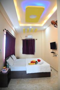 a hotel room with a bed with flowers on it at Sheethal comforts-Chamundi hill view in Mysore
