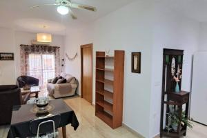 a living room with a table and a couch at Apartamento Calle Real in Martos