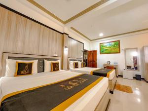 a hotel room with two beds and a bathroom at Sigiriya Kingdom Resort in Dambulla