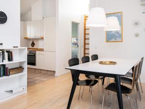 a kitchen and dining room with a table and chairs at 8 person holiday home in Aabenraa-By Traum in Løjt