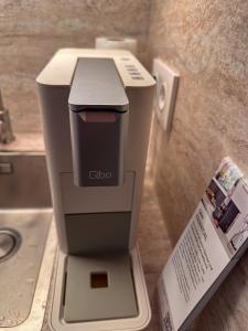 a hair dryer sitting on a counter next to a sink at Secret Home mit Seeblick Ruppinersee in Neuruppin