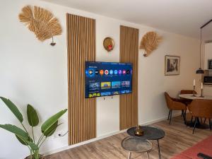 a living room with a tv on a wall at Secret Home mit Seeblick Ruppinersee in Neuruppin