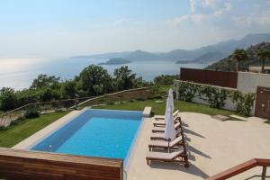 a swimming pool with a view of the ocean at Villa Hedonism in Sveti Stefan