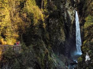 people standing on a bridge in front of a waterfall at Apartment in Bramberg near Ski Lift in Bramberg am Wildkogel