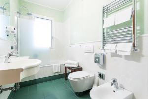 a white bathroom with a toilet and a sink at West Florence in Campi Bisenzio +24 photos