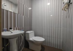 a bathroom with a white toilet and a sink at Fast Hotel Idaman Near To IIUM KL in Kuala Lumpur +54 photos