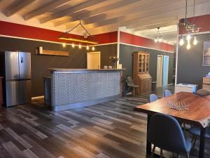 a room with a bar and a table and a kitchen at Rhin Quartier Ferienwohnung Loft-Style in Rheinsberg +11 photos