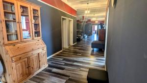 a hallway with a large wooden cabinet in a house at RhinQuartier FeWo Loft-Style in Rheinsberg +14 photos