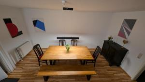 a dining room with a wooden table and chairs at am-hoeben in Fehmarn