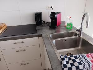 a kitchen counter with a sink and a toaster at Studio Louisa met prachtig zeezicht in Ostend