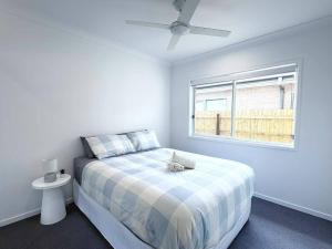 a white bedroom with a bed and a window at Home Blanc - Brand New, Peaceful & Well Equipped in Ripley