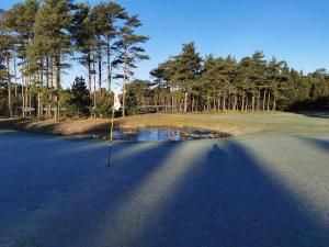 a shadow of a golf club on a golf course at Seaside Escape in Ho Bay - By Traum Ferienwohnungen in Ho +34 photos