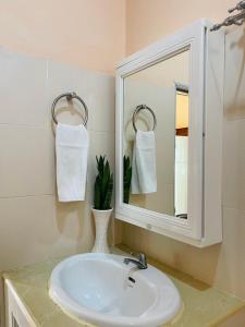 a bathroom with a sink and a mirror at Tawan Shine in Chiang Rai +17 photos