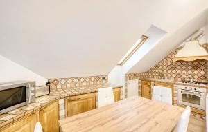 a kitchen with wooden cabinets and a wooden table at 2 Bedroom Cozy Apartment In Uscio in Uscio