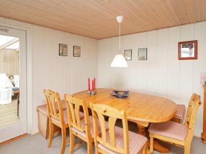 a dining room with a wooden table and chairs at 4 person holiday home in Struer in Struer