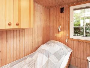 a small room with a bed in a cabin at 4 person holiday home in Struer in Struer