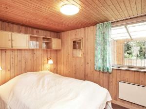 a bedroom with a bed and a window in it at 4 person holiday home in Struer in Struer