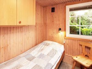 a small room with a bed and a window at 4 person holiday home in Struer in Struer +32 photos