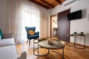 a living room with a couch and a table at Ariadne de Potie Maisonette - Chania Old Town in Chania