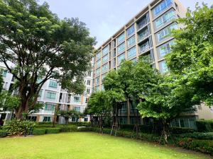 a large building with a lawn in front of it at Condo is next to the mall Big swimming pool 2 in Chiang Mai