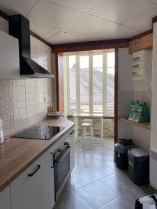 a kitchen with a sink and a stove top oven at Appartement meublé 52m2 in Bagnères-de-Bigorre