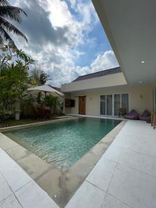 a swimming pool in front of a house at Luxury 3 Bed Villa in Kuta with Pool in Kuta Lombok