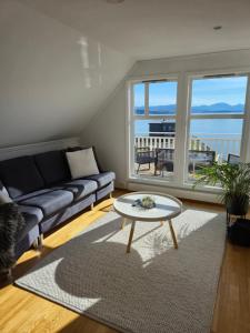 a living room with a couch and a table at White Cat Guesthouse in Ålesund