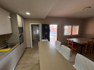 a kitchen and dining room with a counter and a table at Casa Rana 