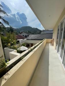 a balcony with a view of a house at Luxury 3 Bed Villa in Kuta with Pool in Kuta Lombok