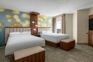 a hotel room with two beds and a television at Anaheim Marriott Suites in Anaheim +25 photos