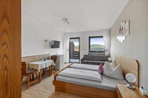 a living room with a bed and a couch at Geräumiges Ferienhaus Mit Garten In Rittsteig in Neukirchen beim Heiligen Blut