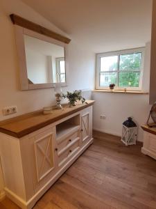 a bathroom with a vanity with a mirror at Haus Waldstein Gipfelstürmer in Weißenstadt
