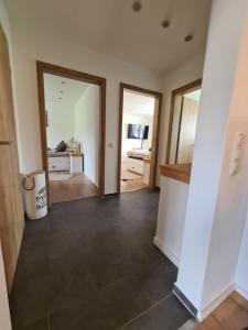 an empty room with a hallway with two mirrors at Waldstein Terrassen in Weißenstadt